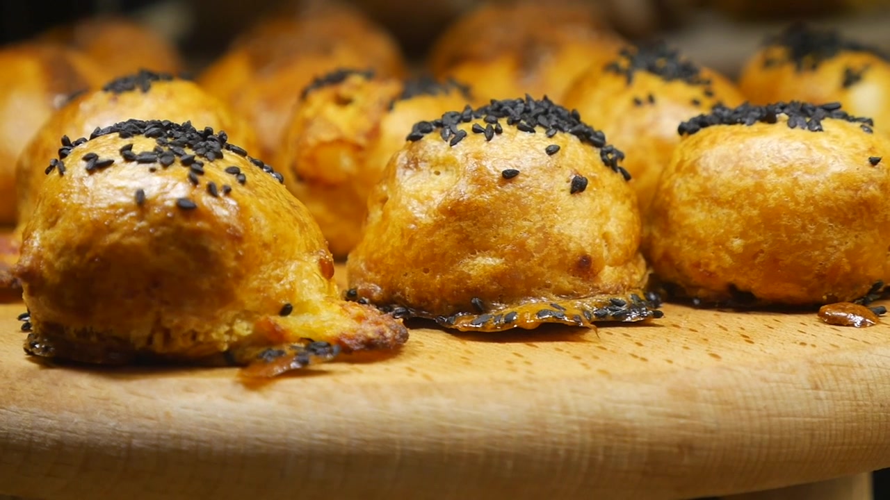 Freshly Baked Savory Pastries Topped with Black Sesame Seeds