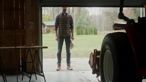 man leaving the barn/garage on farm