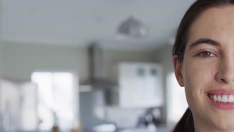 portrait of happy caucasian woman looking at camera at home