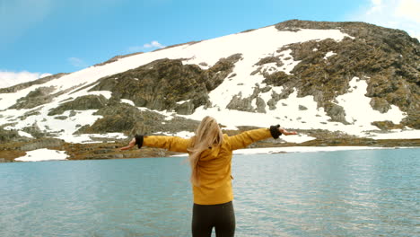 woman enjoying the scenery of a beautiful mountain lake