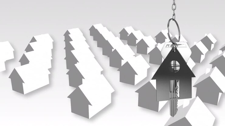Hausschlüssel und Schlüsselanhänger hängen über 3D-Hausmodellen im Hintergrund