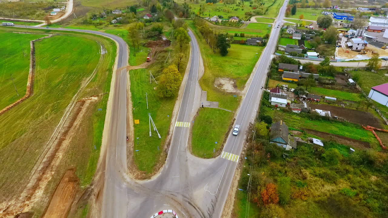 vista de drones de la construcción de carreteras suburbanas. camiones de carga que conducen por carreteras rurales