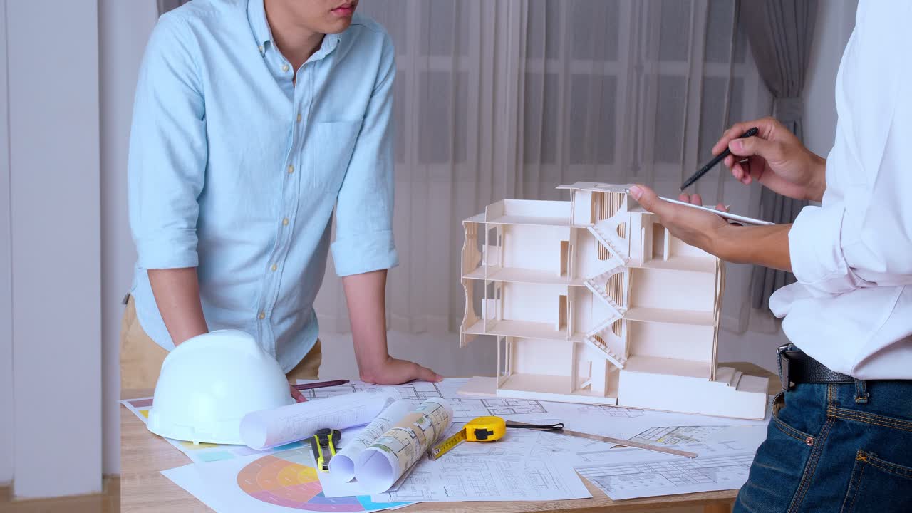 Architect Working On An Architectural Model With Tablet