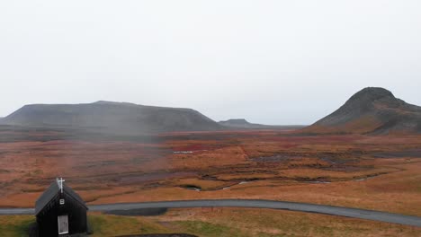 remote wooden church in misty autumn landscape in nordic iceland