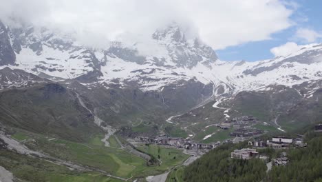 matterhorn covered in clouds with breuil-cervinia in the valley