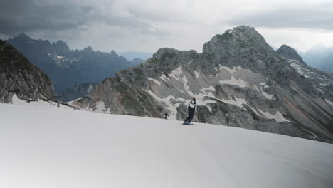 woman skiis past the camera towards the hiker and stops to great him