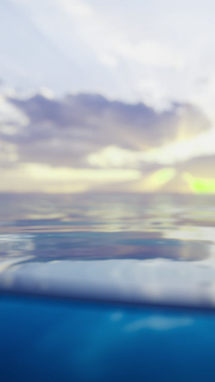 Calm ocean water reflects clouds and sunset colors in serene beauty
