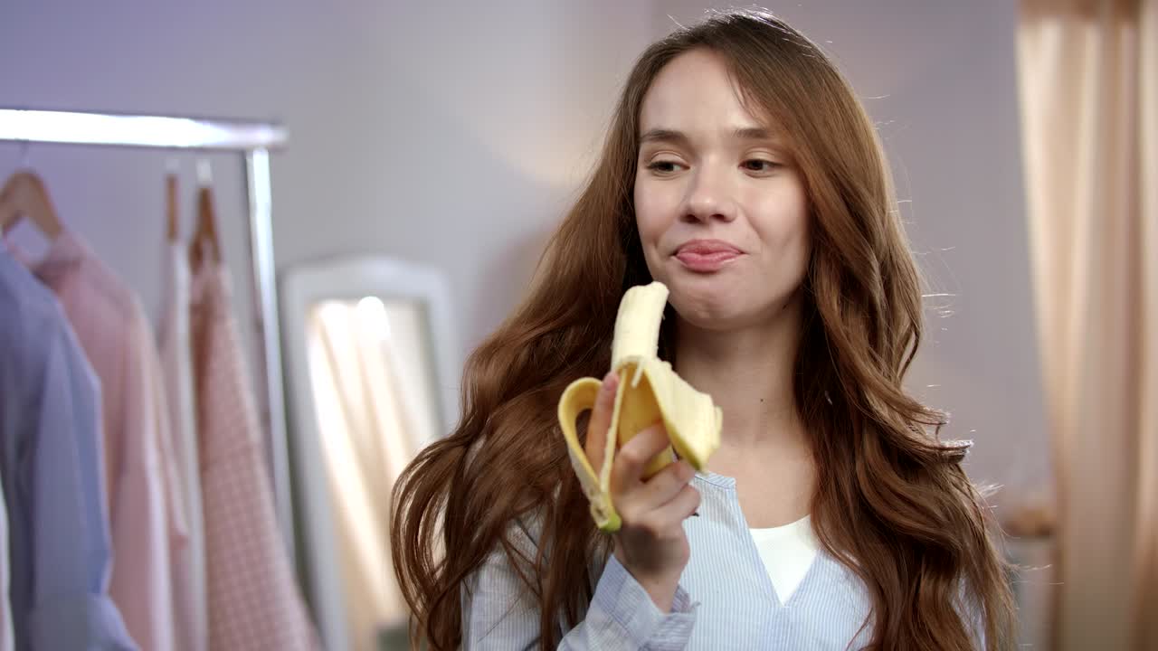 Happiness woman eating banana. Healthy tropical fruit for female diet