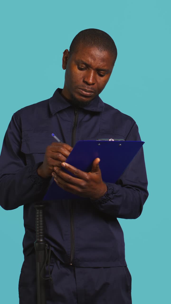 African American Security Guard Writing on Clipboard