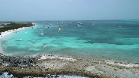 Kite-surfer-rounds-bend-in-crasky-bay,-los-roques-venezuela,-aerial-tracking