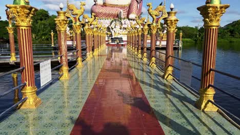 the way to the big buddha statue is guided by pillars with golden figures on top of them