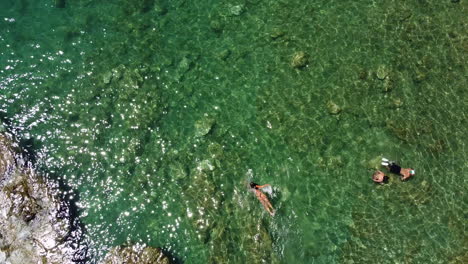 People-having-a-bath-on-the-crystal-clear-waters-at-Cardellino-beach,-Castiglioncello