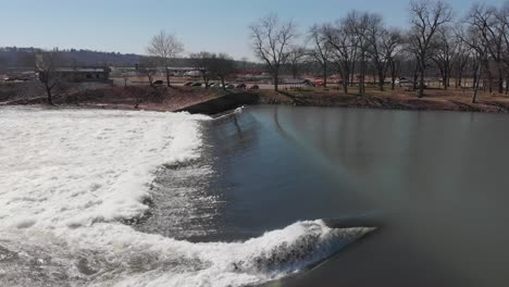 aerial view of the white river lock and dam, in usa - low, tracking, drone shot