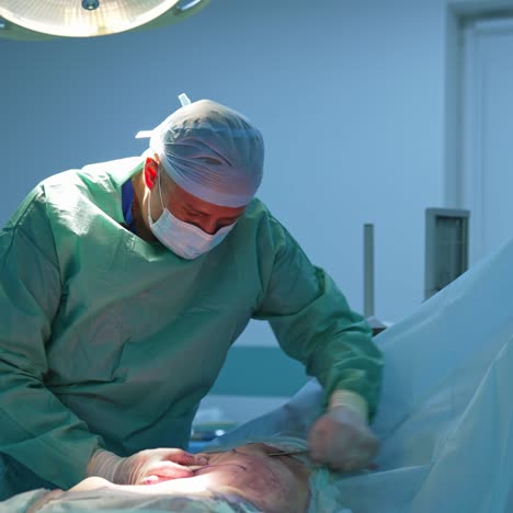 abdominal liposuction. surgeon performing cosmetic surgery on belly in the operating room. body correction in hospital