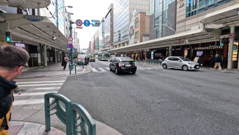 vehicles and pedestrians at a busy intersection