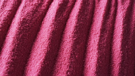 A-close-up-view-of-a-textured-pink-fabric-with-distinct-ridges