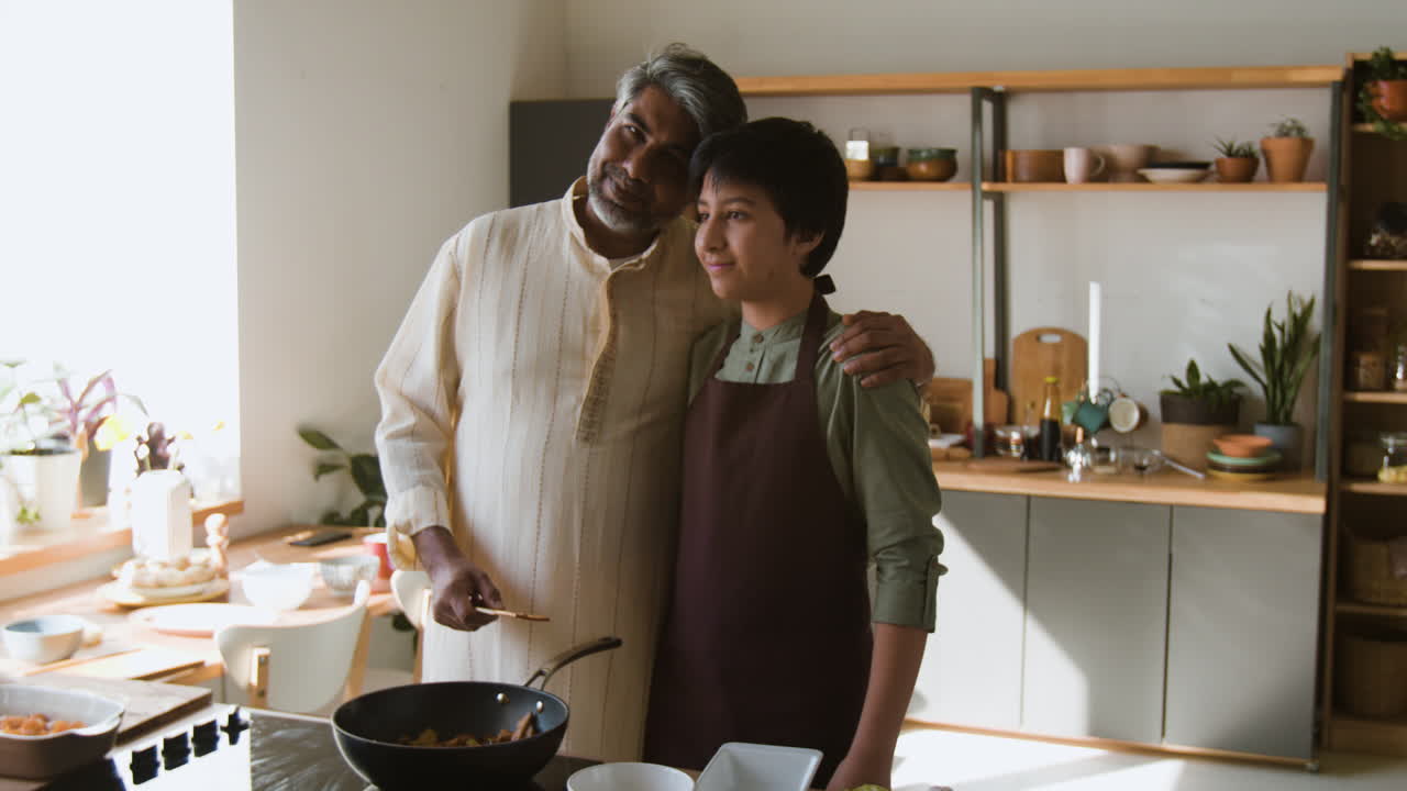 Father and Son Cooking Together in the Kitchen