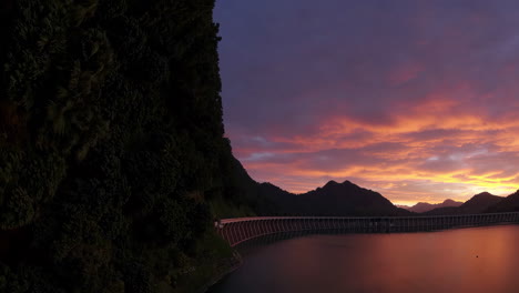 dramatic sunset over a dam and reservoir