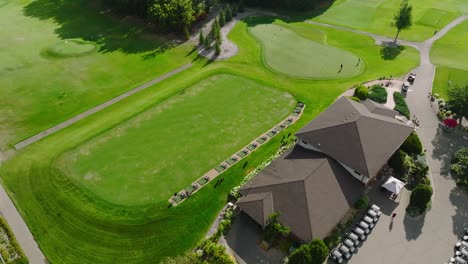 golf course practice area with driving range and putting green at a country club