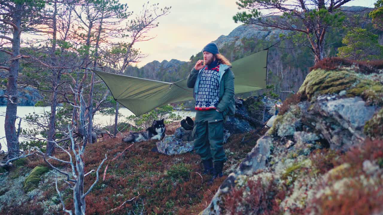 A Man and His Dog Have Set Up Camp by the Shores of Kattavatnet Lake in Roan, Trøndelag, Norway - Static Shot