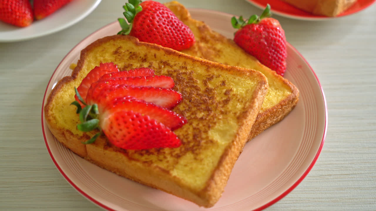 french toast with fresh strawberry on plate