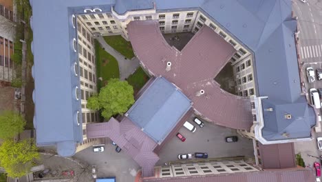 aerial drone shot pulling straight up revealing a mid century building