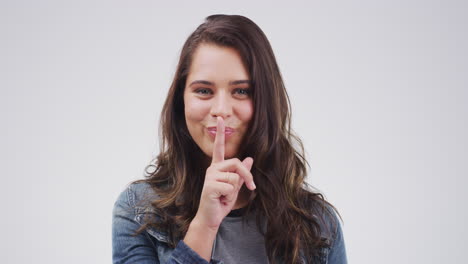 woman making a "quiet" gesture