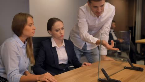 few businesspeople working with modern future transparent glass interface display