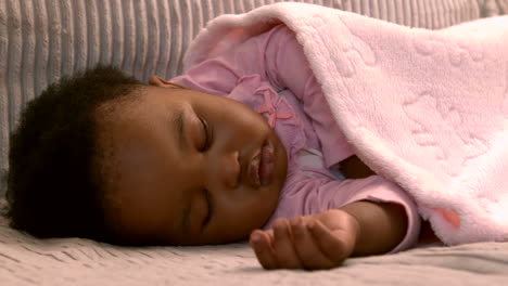 baby girl sleeping on the sofa