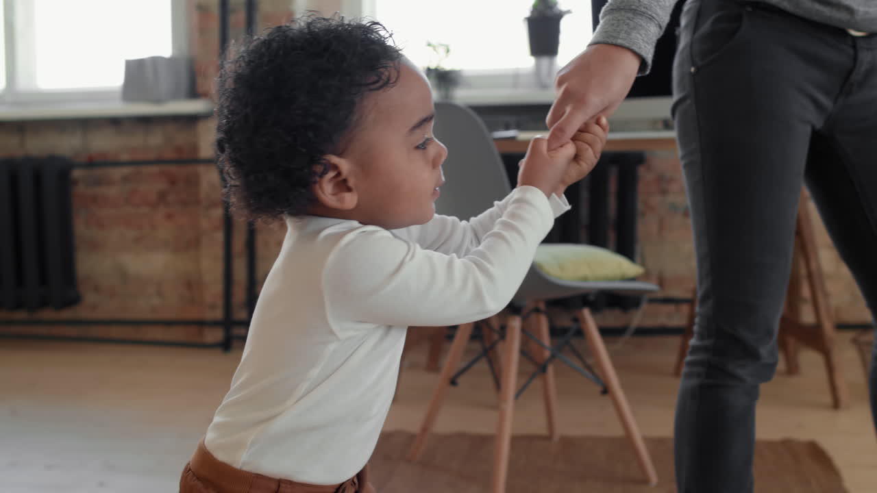 Fussy Toddler Boy Holding Mothers Hand