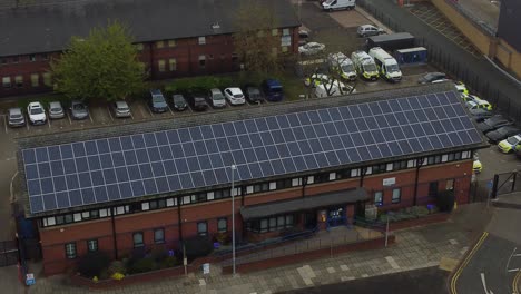 Widnes-town-police-station-with-solar-panel-renewable-energy-rooftop-in-Cheshire-townscape-aerial-rising-view