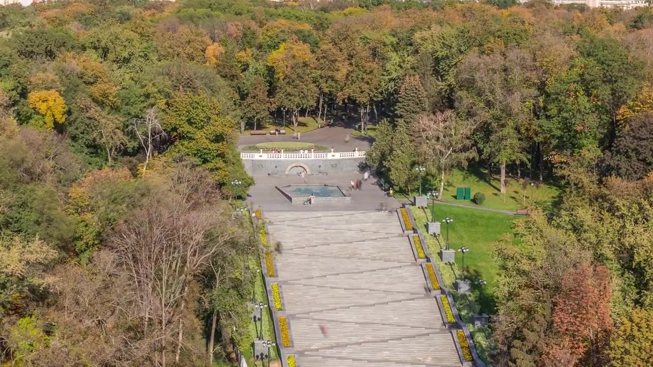 Panoramiczny widok z lotu ptaka na schody z fontannami w Ogrodzie Szewczenki timelapse. Park z żółtymi, czerwonymi i zielonymi drzewami jesiennym wieczorem. Charków, Ukraina
