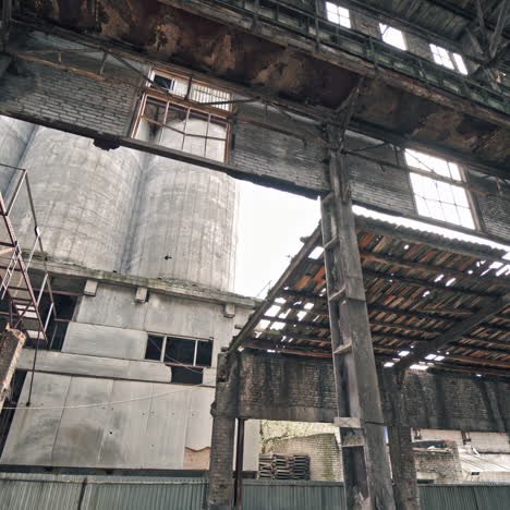 ruins of an old factory. interior of an abandoned derelict industrial structure.