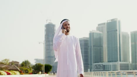 man walking and talking on phone in dubai