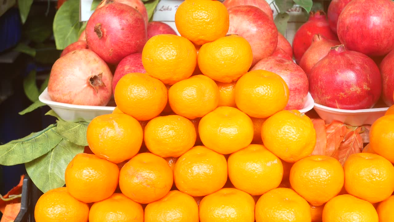 Fresh Oranges and Pomegranates at a Market