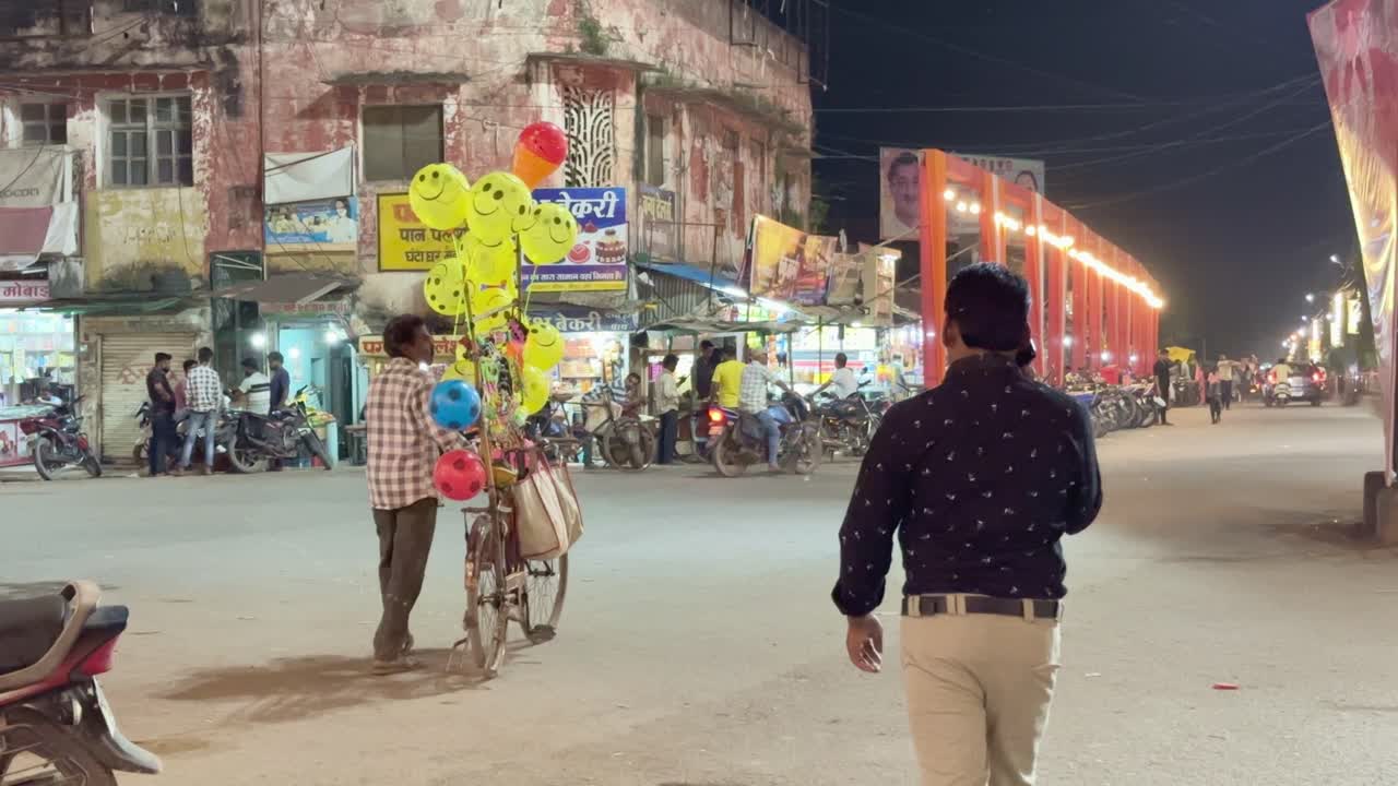 Balloon seller in India with lots of smiley balloons