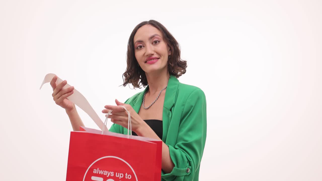 Woman looking at a receipt from a shopping bag