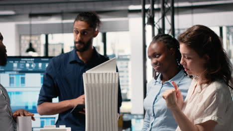 vertical video contractors and engineers reviewing 3d models and construction blueprint