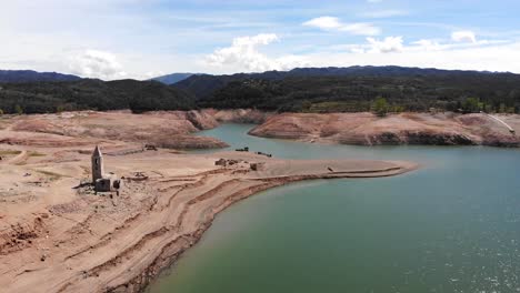 Empty-reservoir-with-a-ruined-church.-Aerial-shot