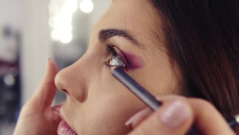 Creating-purple-smokey-eye-make-up-look-close-up-footage.