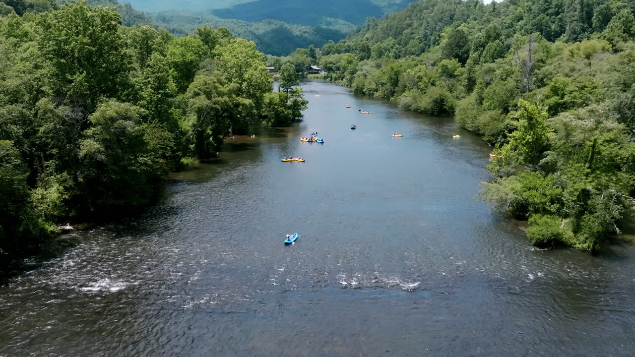 Static aerial drone timelapse of people in tubes going down the Hiawassee River in Tennessee in the summer.