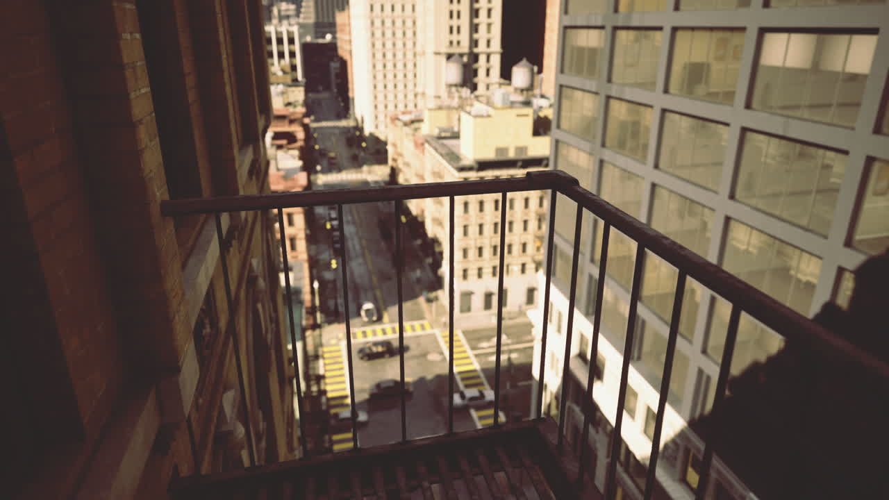 View from a balcony overlooking a busy city street in urban setting
