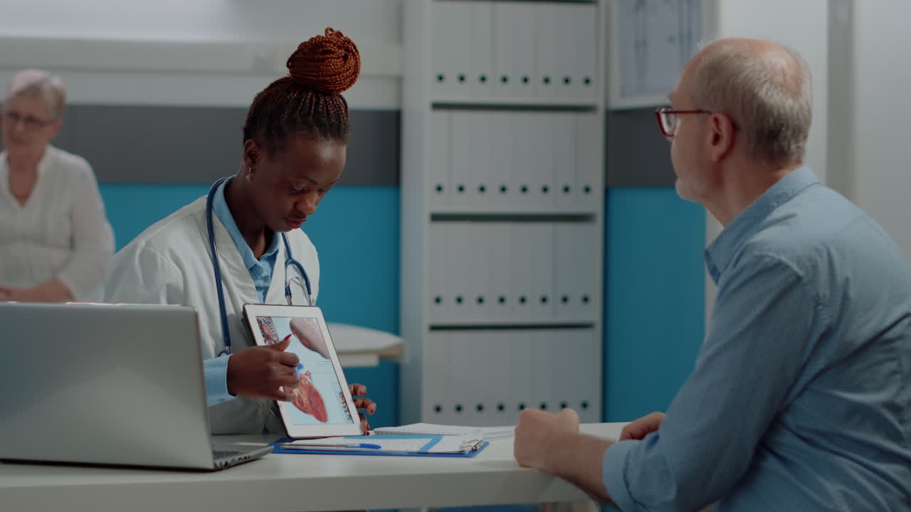 Doctor Explaining Heart Anatomy to Patient on Tablet