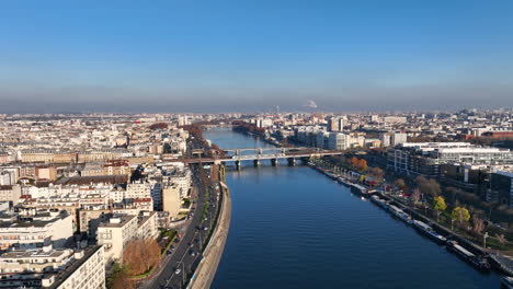 aerial charm: paris, seine, île de la jatte, la défense, and a sunny barge cross