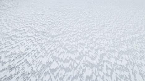 windswept snow pattern spreads jagged sharp peaks across ice white lake in suwalki gap masuria poland