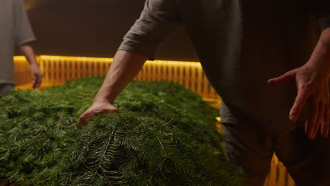 preparing a christmas fir tree arrangement