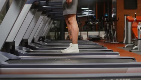 person walking on treadmill in gym