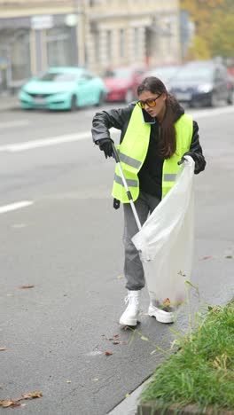 mujer limpiando la basura en la calle de la ciudad