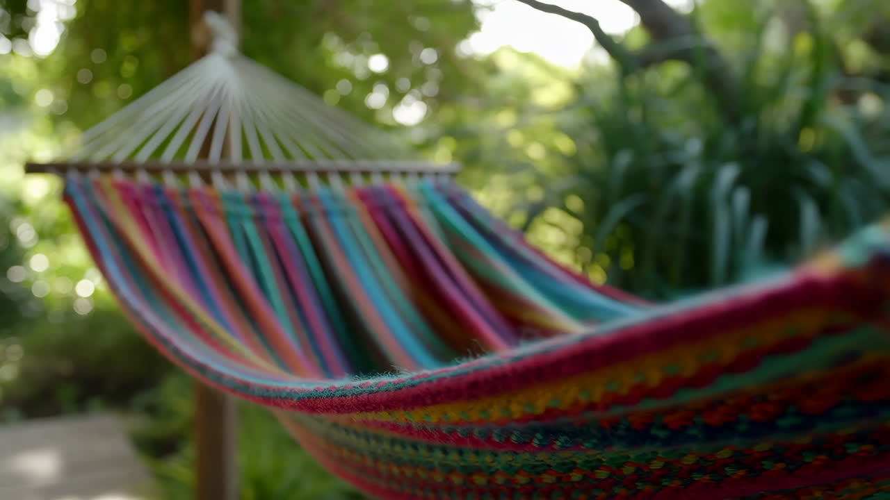 A vibrant, colorful hammock in a lush outdoor garden setting