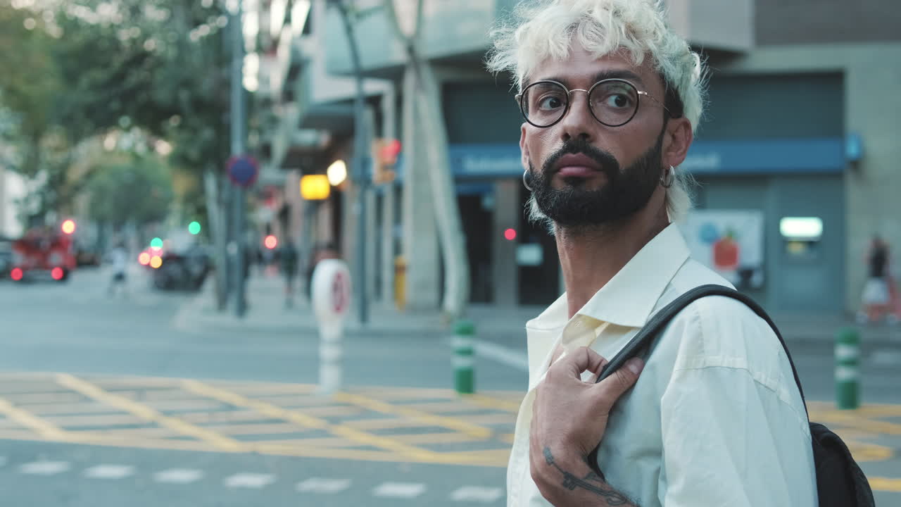 Young Man with Bleached Hair and Beard Standing on City Street